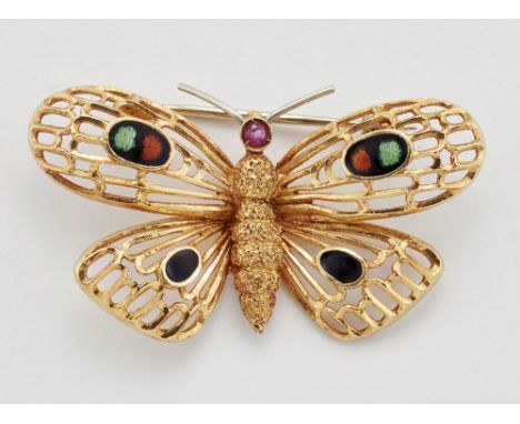 A RUBY AND ENAMEL BUTTERFLY BROOCH, modelled with a round-cut ruby thorax and pierced wings filled with black, green and oran