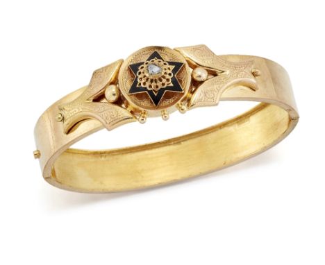 A DIAMOND AND BLACK ENAMEL BANGLE, a rose-cut diamond within a black enamel star frame between foliate engraved scrolls, to a