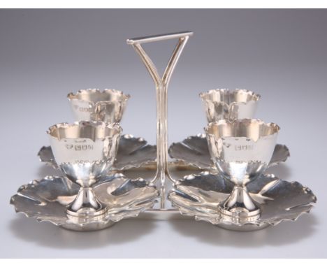 AN EDWARDIAN SILVER EGG CRUET SUITE,&nbsp;by Goldsmiths &amp; Silversmiths Co Ltd, London 1903, the wirework frame stand hold