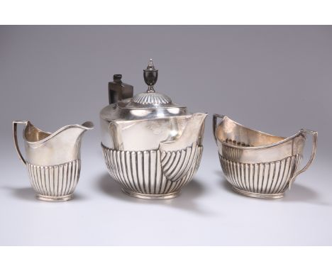 AN EDWARDIAN SILVER THREE-PIECE TEA SERVICE, by William Hutton &amp; Sons, London 1908,&nbsp;oval form with half fluted decor