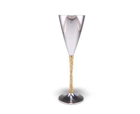 AN ELIZABETH II PARCEL-GILT SILVER CHAMPAGNE FLUTE,&nbsp;by Stuart Devlin, London 1978, the plain conical cup raised on a tex