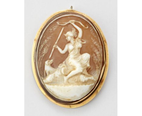 A SHELL CAMEO BROOCH, depicting Diana seated with a bow and arrow and a hound at her side, in a plain frame marked '750'. 4.8