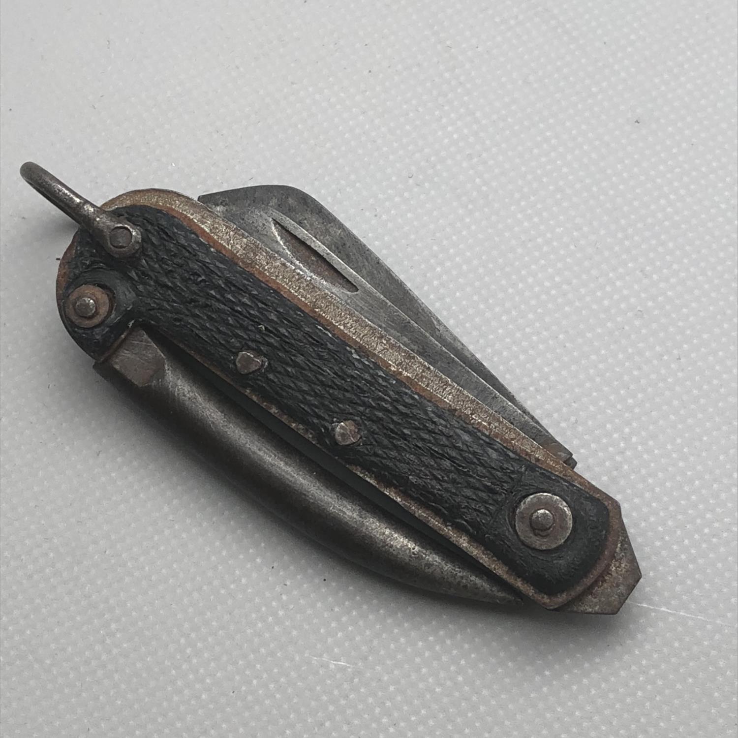 A British Military Issue Pocket clasp knife with marline spike and tin