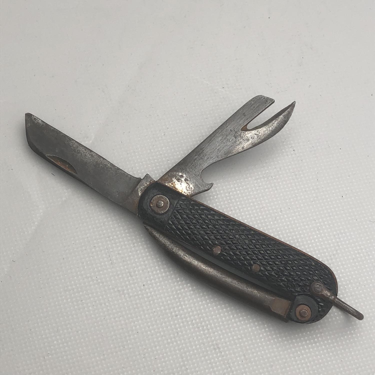 A British Military Issue Pocket clasp knife with marline spike and tin ...