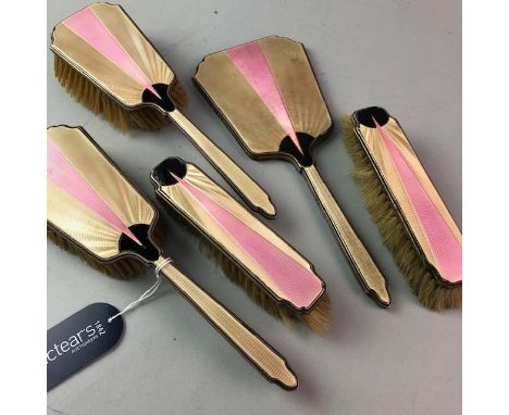 SILVER AND GUILLOCHE ENAMEL VANITY SET, with London hallmarks, comprising hand mirror, two clothes brushes and two hairbrushe