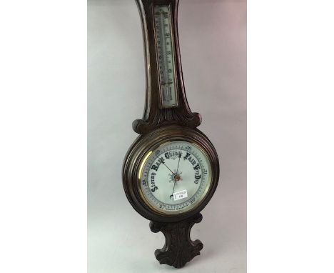 EDWARDIAN WHEEL BAROMETER WITH THERMOMETER, contained in a carved oak case, 90cm high