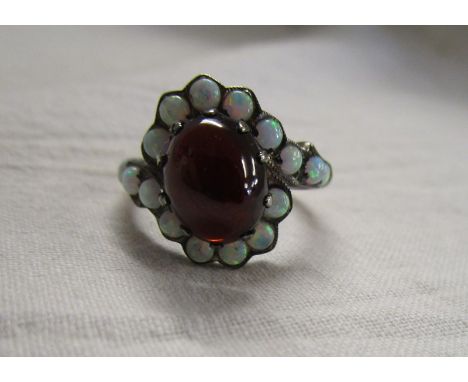 Cabochon garnet and water opal set ring