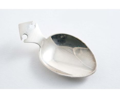 A SMALL CADDY SPOON with a "notched" angular lug handle by H. Wilkinson, Sheffield 1910;  2.3"  (5.8 cms) long;  0.3 oz