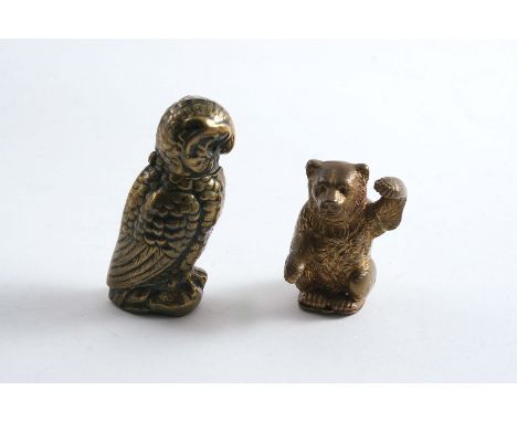 A VICTORIAN BRASS VESTA CASE in the form of an owl with button-operated cover, and a later brass vesta in the form of a bear;