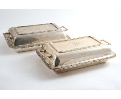 A PAIR OF EARLY 20TH CENTURY CUSHION-SHAPED ENTREE DISHES & COVERS of rounded oblong form with gadrooned borders & an engrave
