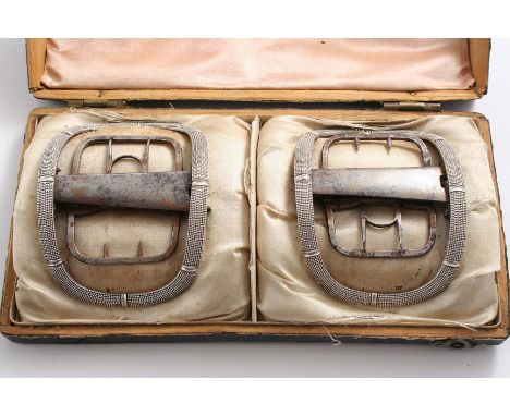 A GEORGE III CASED PAIR OF MOUNTED STEEL SHOE BUCKLES with narrow, textured borders and "patent", quick release mechanisms, o