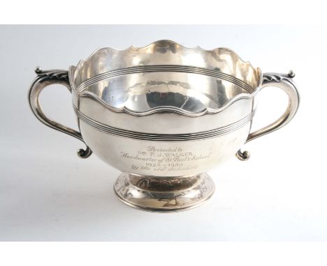AN EDWARDIAN TWO-HANDLED CUP with a shaped rim and reeded girdle around the body, inscribed "Presented to Mr F.J. Walker, Hea