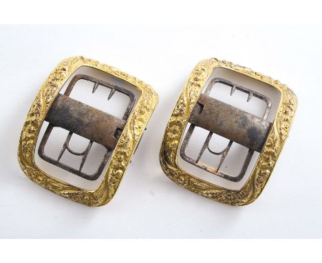 A PAIR OF GEORGE III COPPERGILT SHOE BUCKLES with chased borders and quick release steel chape mechanisms, operated by a butt