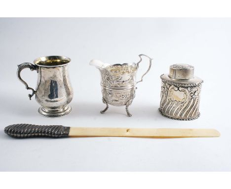 A LATE VICTORIAN EMBOSSED CREAM JUG on lion mask feet, initialled, by George Unite, Birmingham 1897, a Victorian mug, inscrib