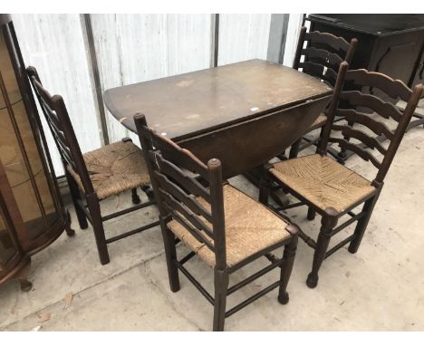 AN OAK DROP LEAF DINING TABLE AND FOUR OAK LADDER BACK DINING CHAIRS WITH RUSH SEATS 