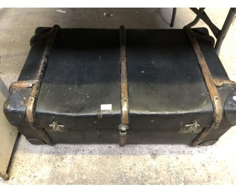 A VINTAGE TRUNK WITH WOODEN SUPPORTS 