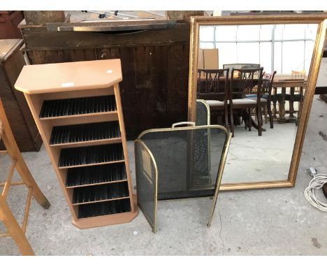 A CD RACK, BRASS FIREGUARD AND GILT FRAMED MIRROR 