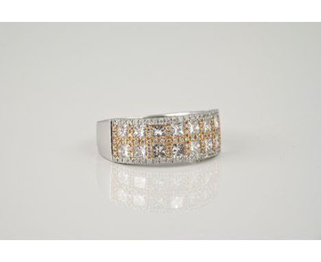 An 18ct two colour gold and diamond double row half eternity ring, the white gold ring set with two rows of seven princess cu