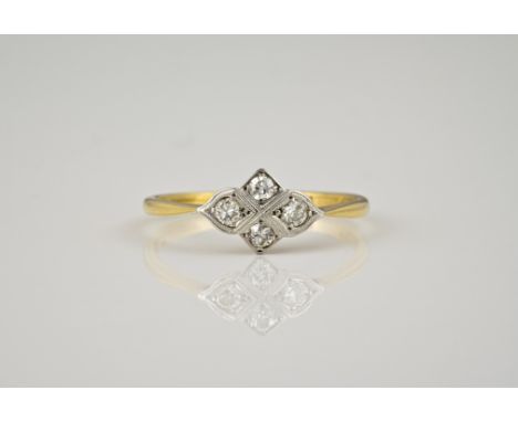 An 18ct gold and platinum four stone diamond ring, 1920s-30s, of four lobed design, millegrain set with old brilliant cut dia