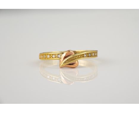 A Welsh 9ct yellow and rose gold and diamond ring by Clogau, the cross over setting with a rose gold heart and row of six bri