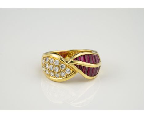 An 18ct gold, ruby and diamond cross over ring, one side pavé set with brilliant cut diamonds, total 0.50cts, the other with 