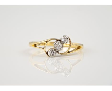 A mid-century 18ct gold and diamond three stone ring, 1930s-40s, the openwork scroll setting with three millegrain set old br