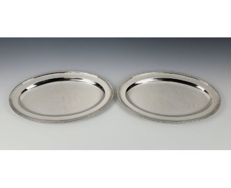 A pair of George III silver oval platters by Paul Storr, London 1798, with gadrooned rims, crested, 13 x 8¾in. (33 x 22.25cm.