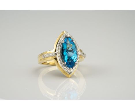 A 14ct gold, topaz and diamond ring, the marquise cut blue topaz within a border of brilliant cut diamonds, the shoulders sim