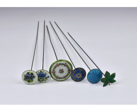 A small collection of silver and enamel hatpins, 20th century, comprising of six pins, to include a pair by Lawrence Emanuel,