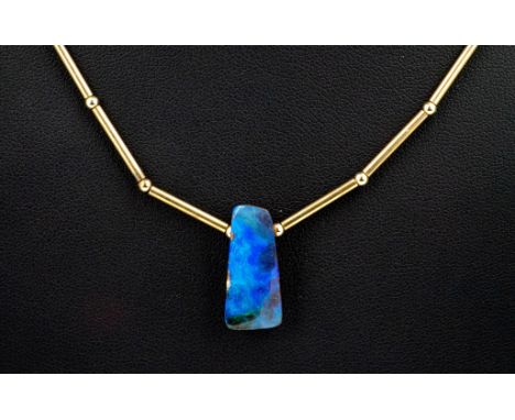 A 9ct yellow gold and opal pendant necklet, the naturalistic boulder opal on a 9ct bar and bead link necklet, 15¾in. (40cm.) 