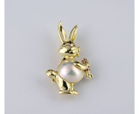 A 14ct yellow gold, Mabé pearl and ruby rabbit brooch, the rabbit with Mabé pearl body, with ruby set eye and holding a ruby 