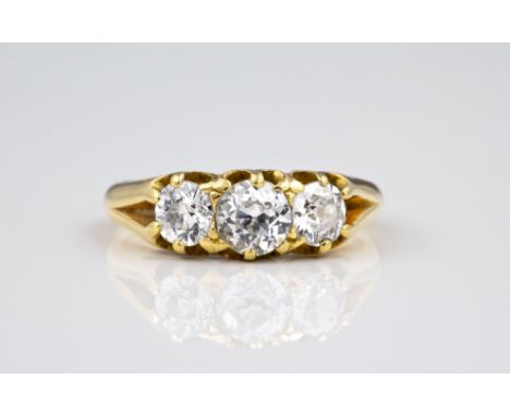 An antique yellow gold and diamond three stone ring, claw set with three old brilliant cut diamonds, total weight approx. 1ct