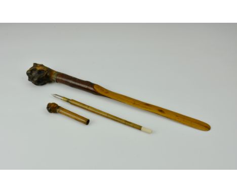 A Victorian novelty treen desktop letter opener, the realistic bull dog head with applied glass eyes, 13¼in. (33.6cm.) long, 