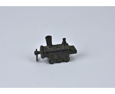 A novelty antique French die-cast miniature fob whistle, fashioned as a steam locomotive, the well detailed whistle stamped t