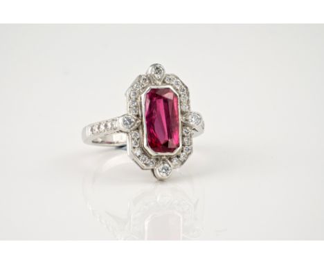 An Art Deco style 18ct white gold, ruby and diamond ring, the rectangular cut 2.59ct ruby within a hexagonal border set with 