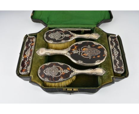 A good Edwardian silver and tortoiseshell dressing set in fitted case, W. J. Myatt & Co., Birmingham 1910, comprising an oval