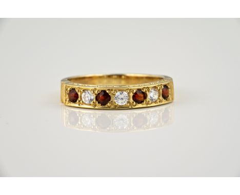 A 9ct gold, garnet and CZ half eternity ring, ring size O.