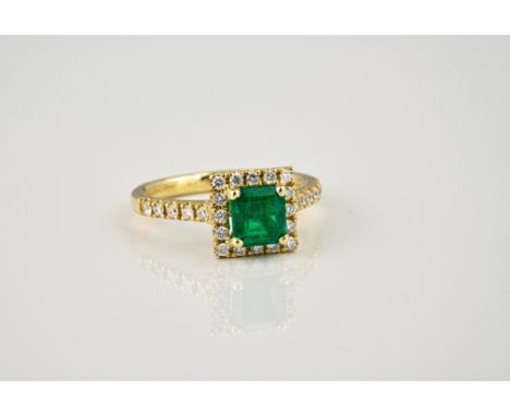 An 18ct yellow gold, Zambian emerald and diamond cluster ring, the 0.86ct emerald within a square halo border of brilliant cu