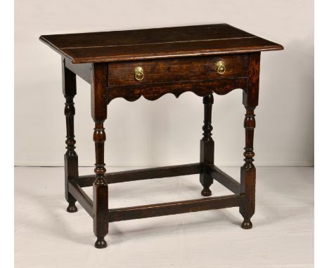 A William III joined oak side table, the rectangular top with moulded lip over a single drawer with original brass ring handl