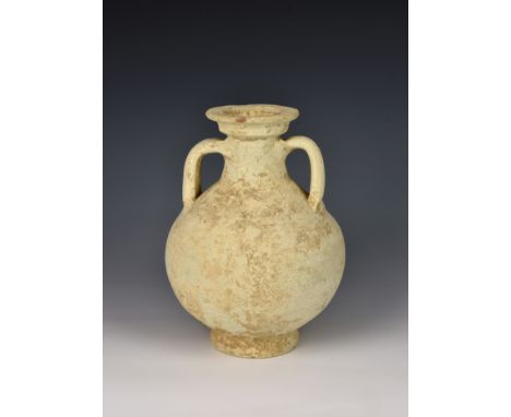 An ancient Roman white clay wine vessel, of globular form with flaring neck with stepped rim, twin loop handles, on circular 