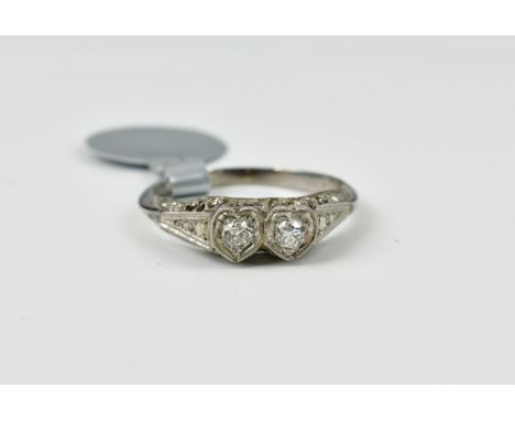 A vintage 18ct white gold, platinum and diamond twin-heart ring,&nbsp;1920s-30s, the two old cut diamonds within twin heart-s