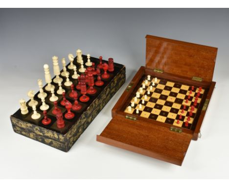 A 19th Century Calvert style chess set, red stained and natural, well turned, the king 10.3cm. high, the pawns 4.3cm. high. (