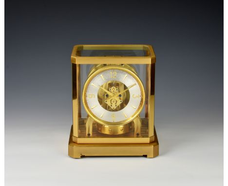 A Jaeger-le-Coultre Atmos clock, glazed gilt brass case with canted corners and inset spirit level to base, the base signed '