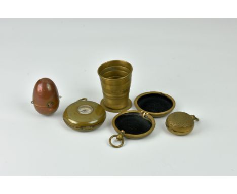 A rare novelty Edwardian integrated compass and collapsible drinking cup, of brass pocket watch form, the front face with cen