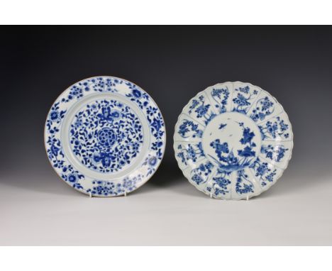 A Chinese porcelain saucer dish, Kangxi period (1662-1722), with scalloped rim, painted with a central circular reserve of fl