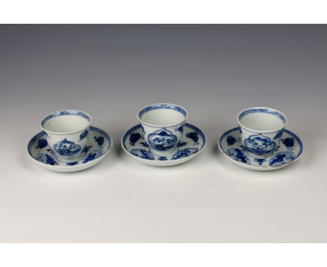 A set of three Chinese blue and white porcelain tea bowls and saucers, Kangxi period (1662-1722), the saucers painted with a 