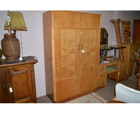 A satinwood bedroom suite, by Maple & Co., of Art Deco design, to include: two door wardrobe, 118cms wide, dressing table and