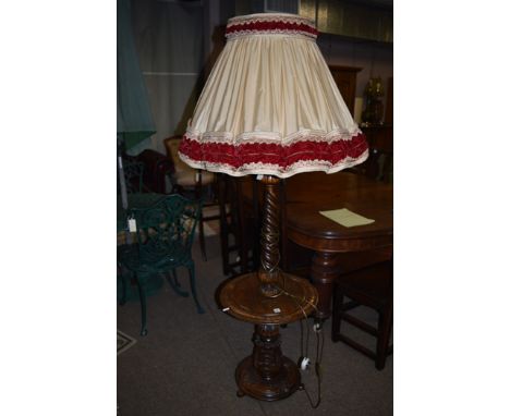 A modern standard lamp/occasional table, with cream and red shade.