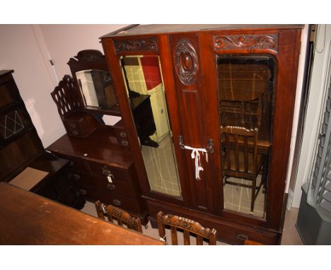A Victorian mahogany wardrobe with bevelled mirror doors and drawer below, 119cm wide; and a matching dressing chest of two s
