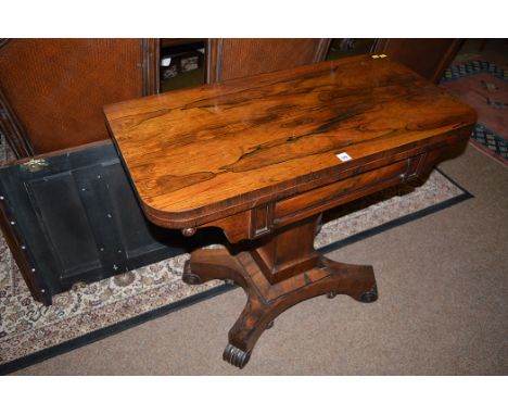 A Victorian rosewood turnover top swivel action card table (missing baize), raised on quatreform base, 91.5cms wide.